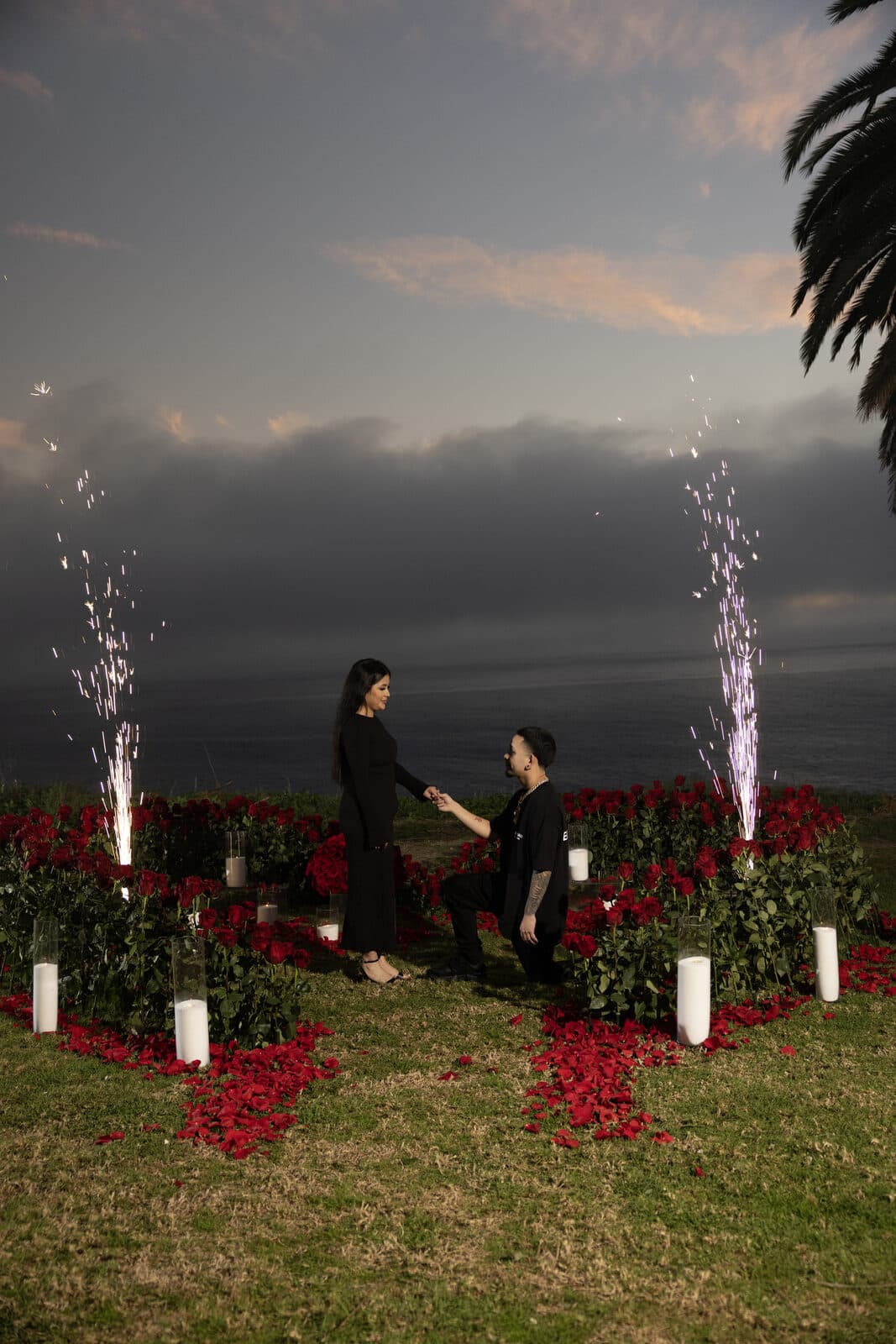 Surprise sunset proposal on a Southern California cliffside with fireworks and a rose-petal heart