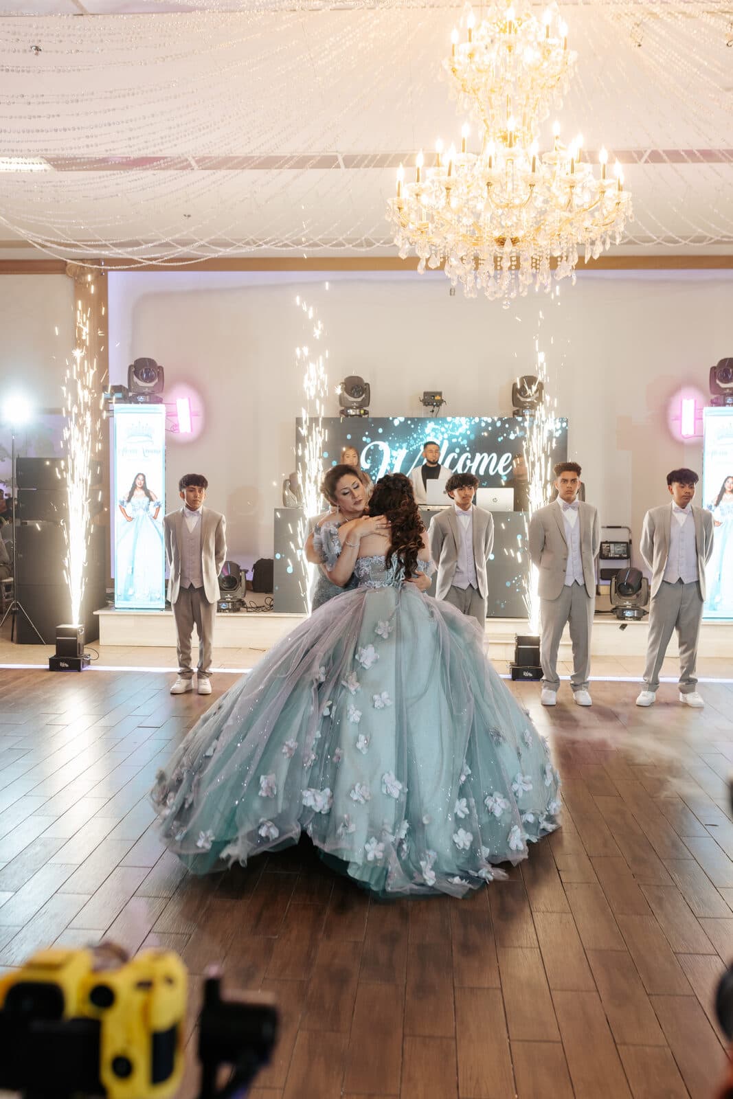 Quinceañera first dance with cold-spark fountains and a blue floral ball gown